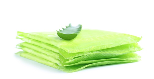 Photo of Stack of menstrual pads and aloe leaf on white background. Gynecological care