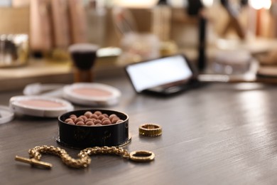 Photo of Blush and jewelry on dressing table indoors, space for text