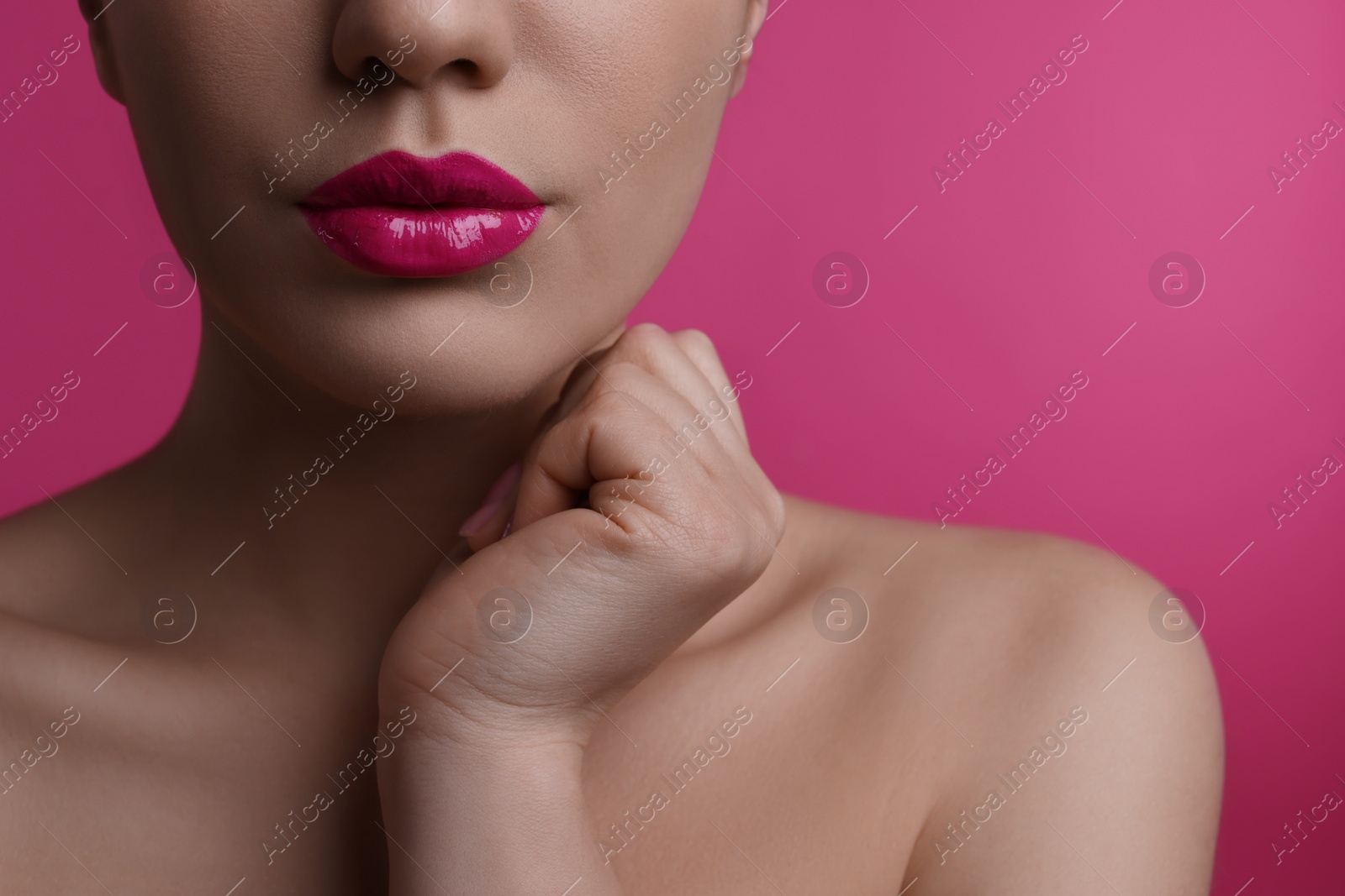 Photo of Closeup view of woman with beautiful full lips on pink background