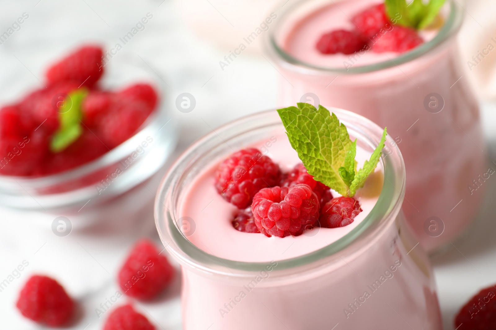 Image of Yummy raspberry smoothie in glass jar on table, closeup
