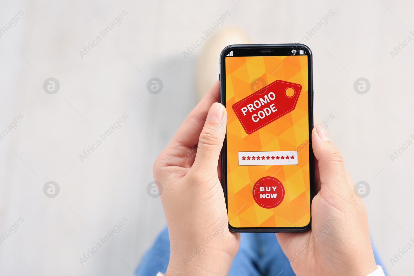 Photo of Woman holding smartphone with activated promo code in online shopping app, closeup. Space for text