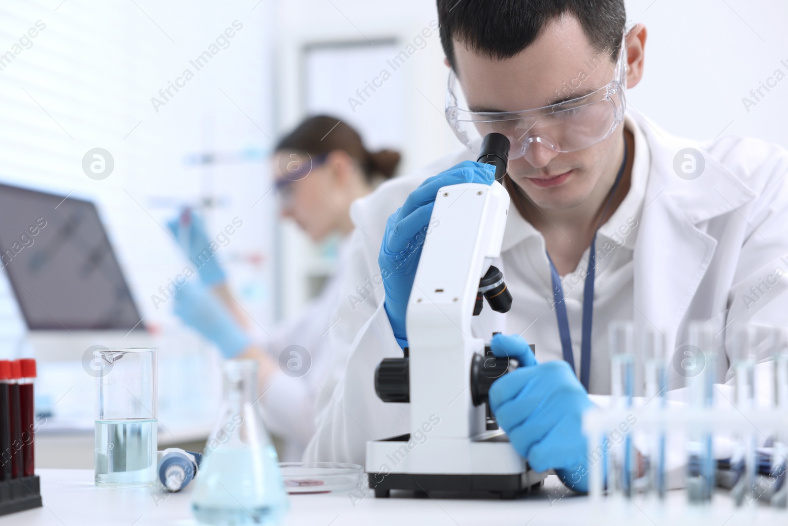 Photo of Scientist working with microscope in laboratory. Medical research