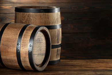 Photo of Wooden barrels on table, space for text