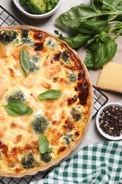 Delicious homemade salmon quiche and ingredients on table, flat lay