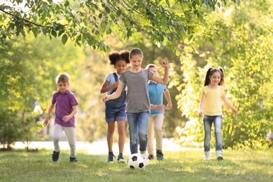 Cute little children playing with ball outdoors on sunny day