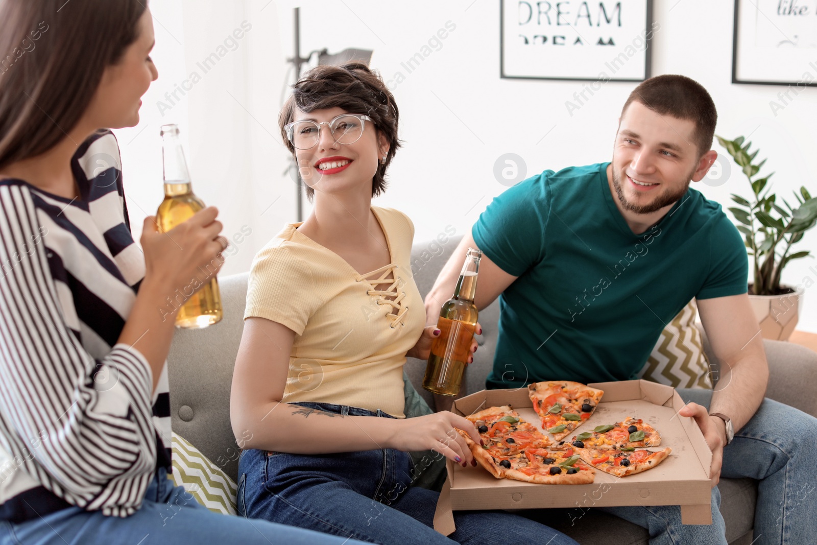 Photo of Young people having fun party with delicious pizza indoors