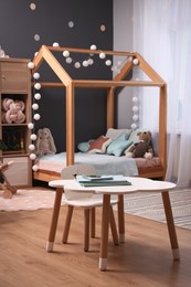 Comfortable house bed in child room. Stylish interior