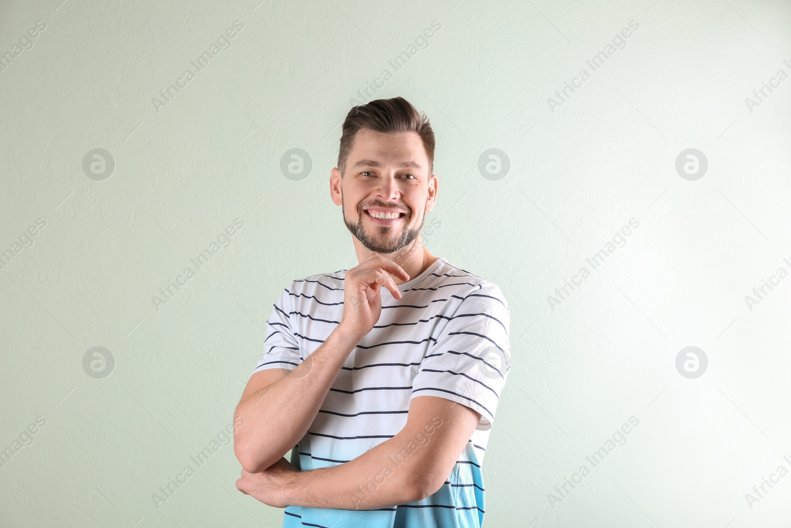 Photo of Charming young man on light background