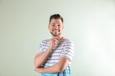 Charming young man on light background