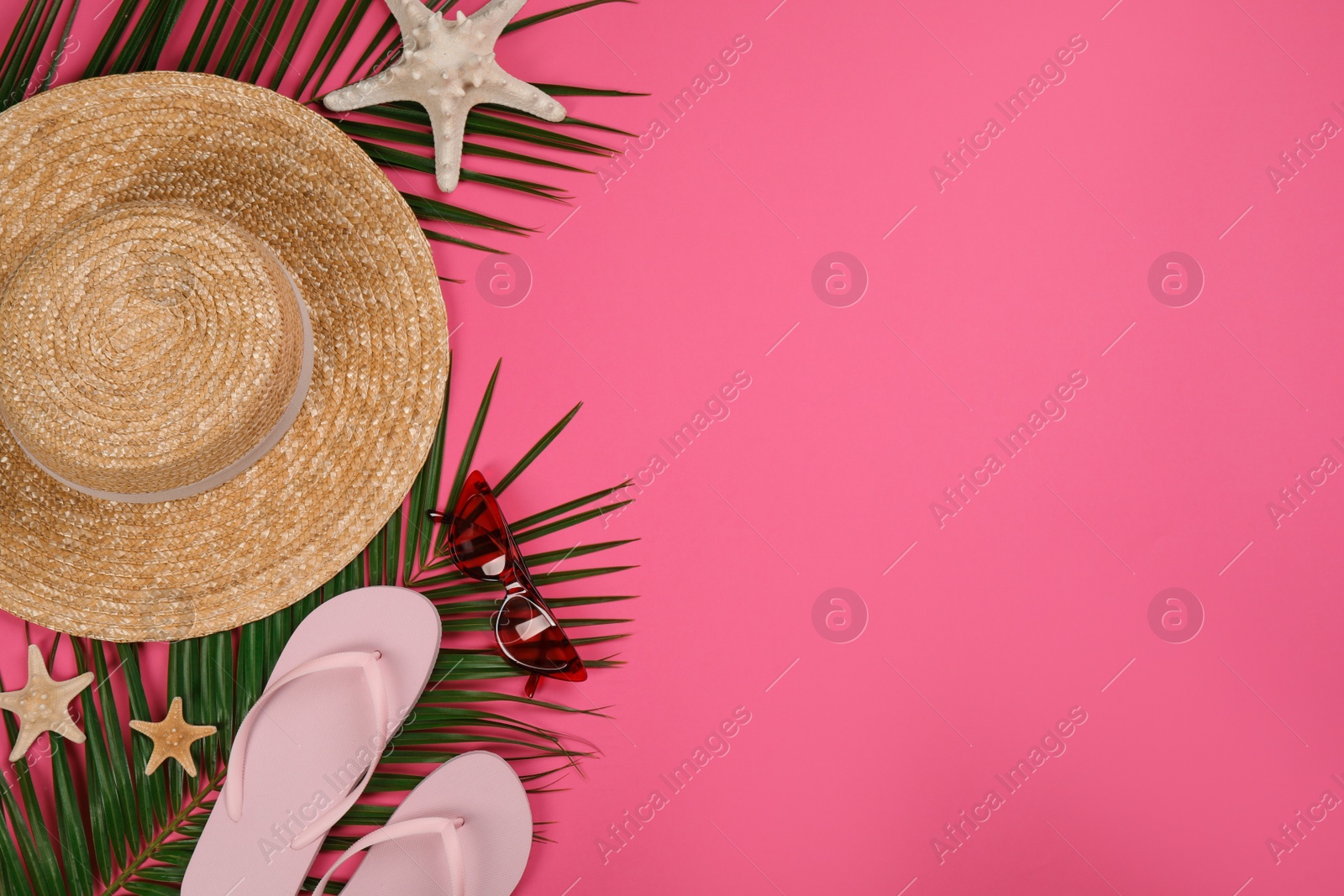 Photo of Flat lay composition with beach objects on pink background, space for text