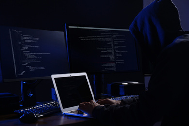 Hacker with computers in dark room. Cyber crime