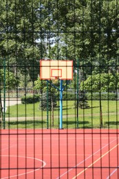 Empty basketball court outdoors on sunny day