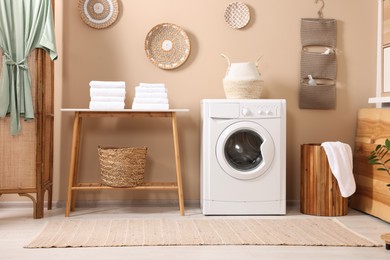 Stylish laundry room with modern washing machine. Interior design