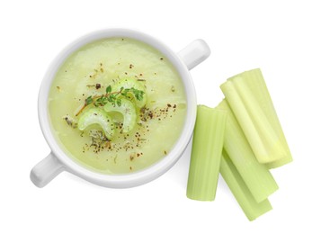 Bowl of delicious celery soup and fresh stalks on white background, top view