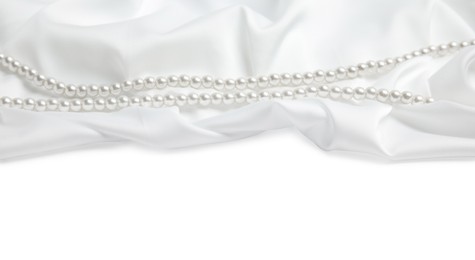 Photo of Beautiful pearls and delicate silk on white background