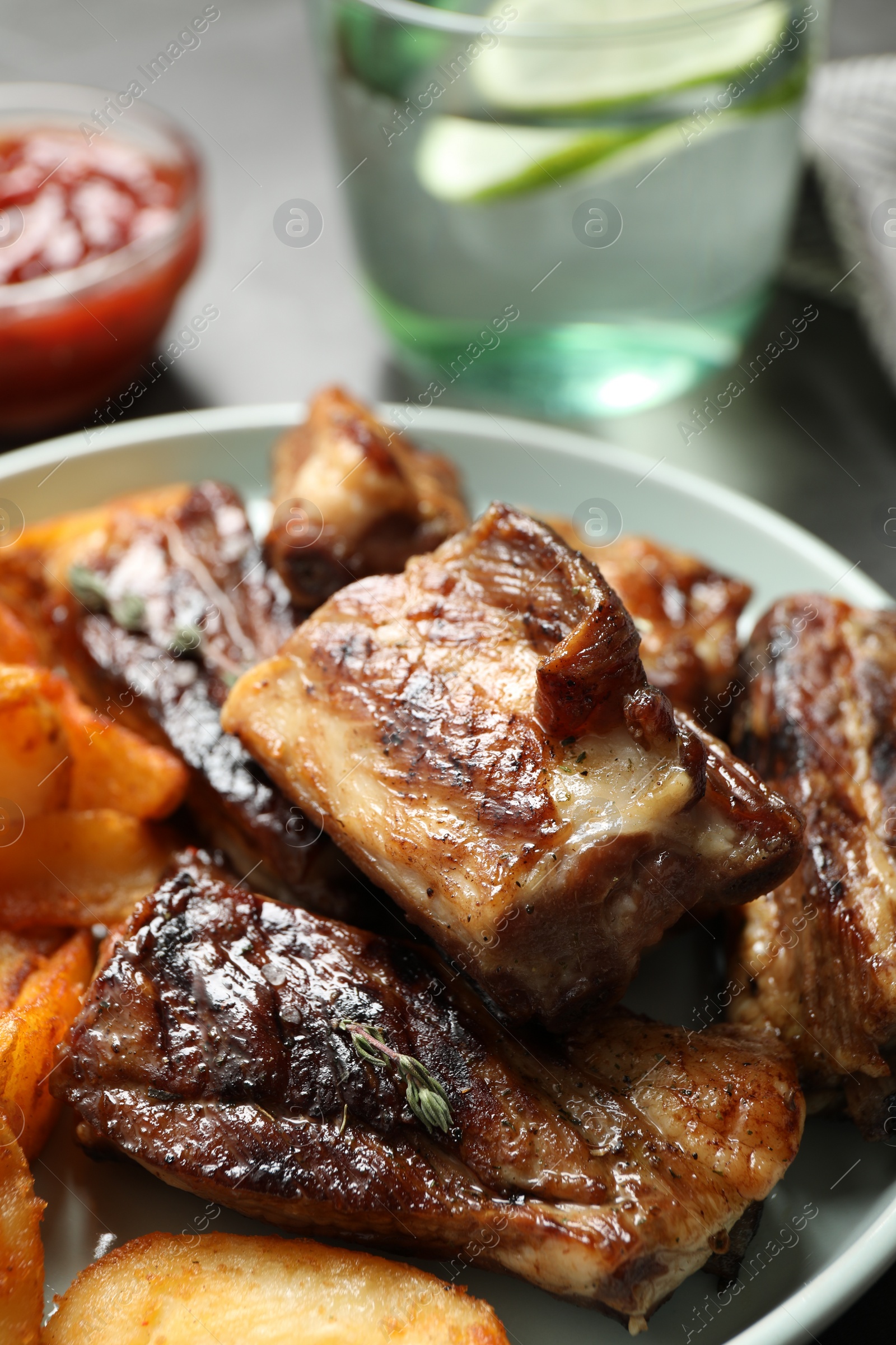 Photo of Delicious grilled ribs on table, closeup view