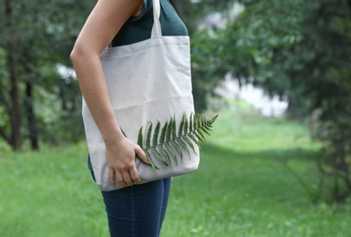 Photo of Woman with eco bag outdoors. Mockup for design