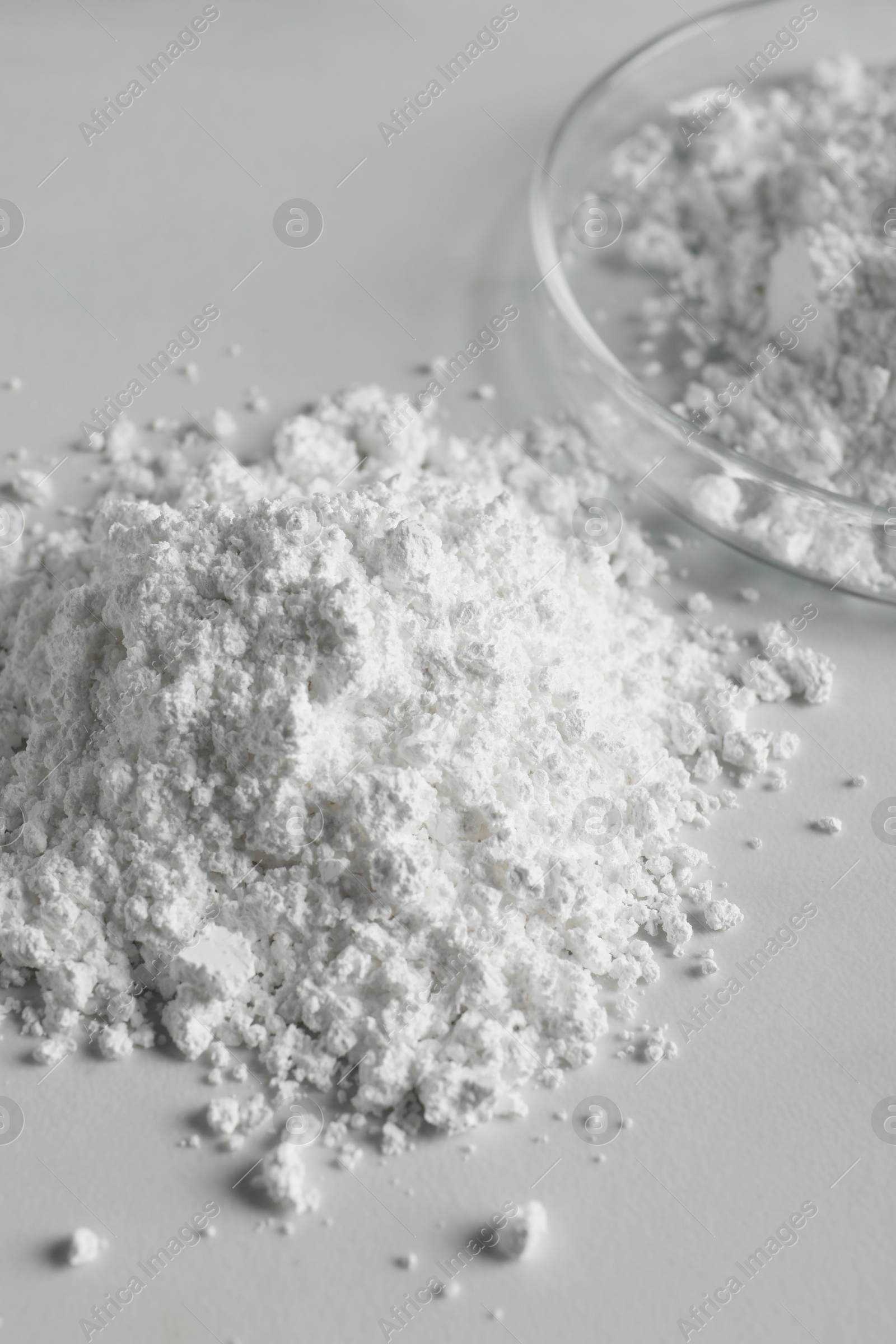 Photo of Heap of calcium carbonate powder on white table