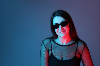 Photo of Portrait of beautiful young woman with sunglasses on color background. Space for text