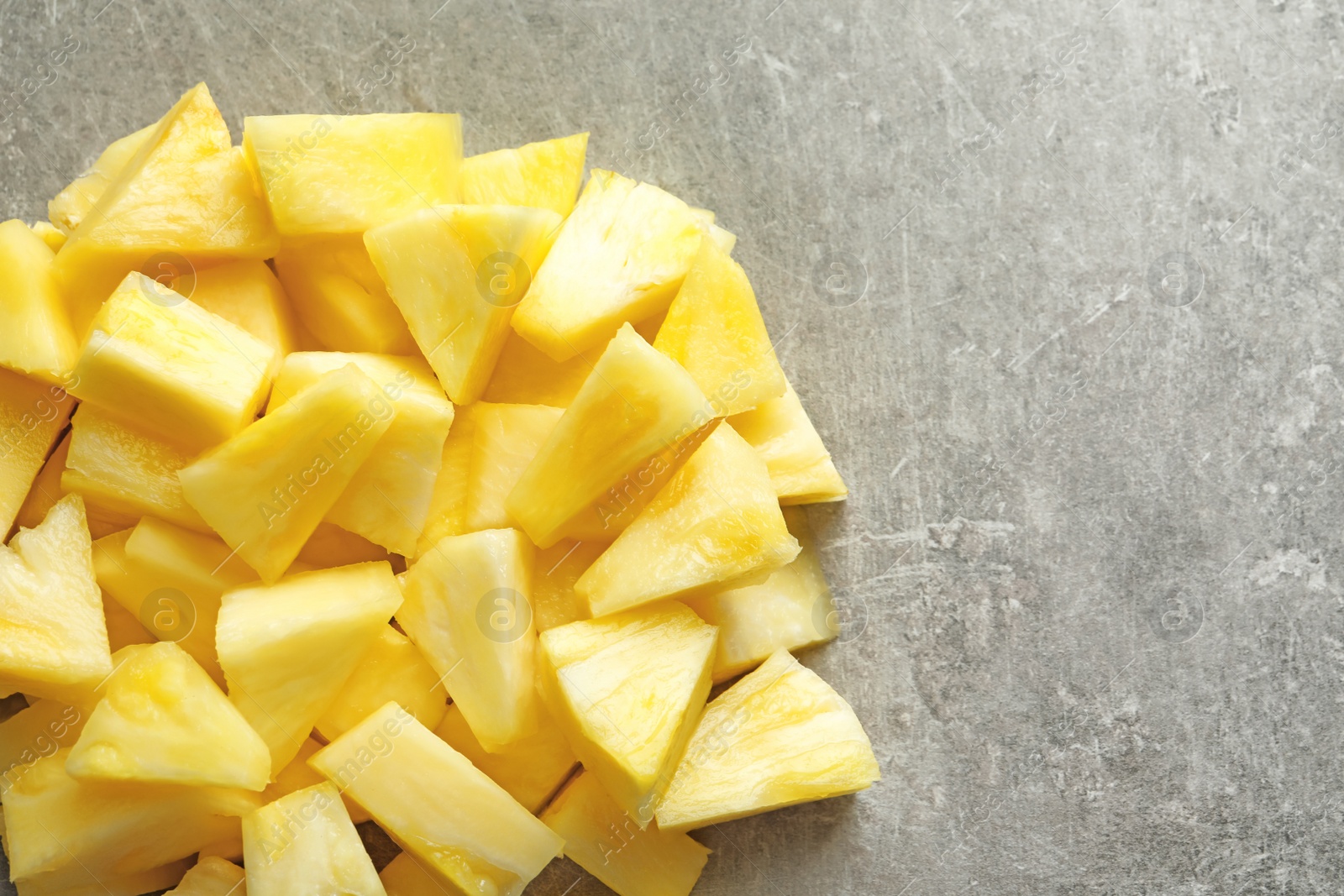 Photo of Slices of fresh pineapple on grey background