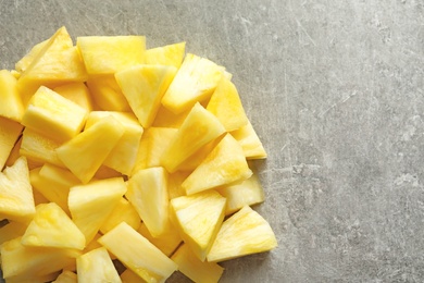 Slices of fresh pineapple on grey background