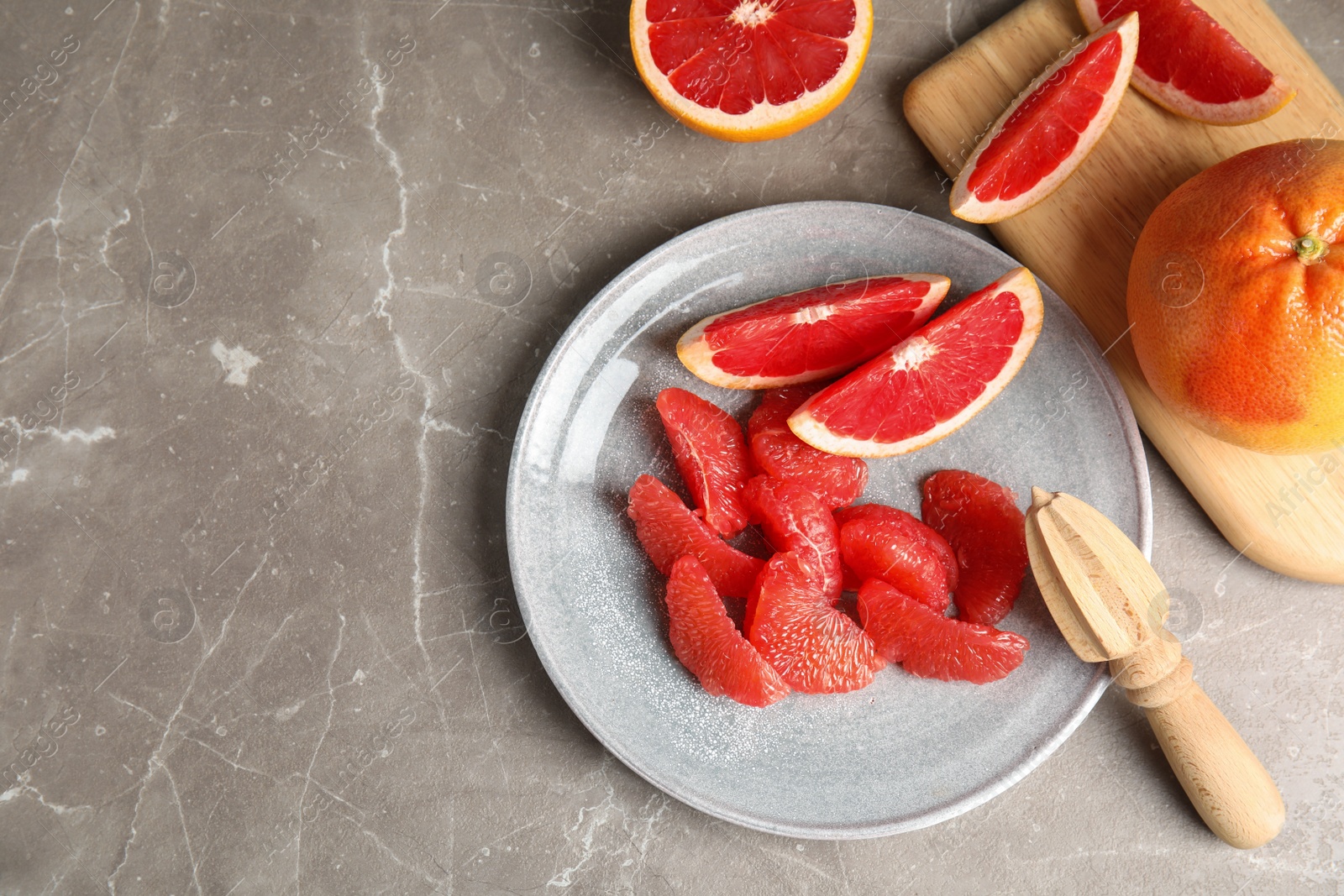 Photo of Flat lay composition with grapefruits and space for text on grey background