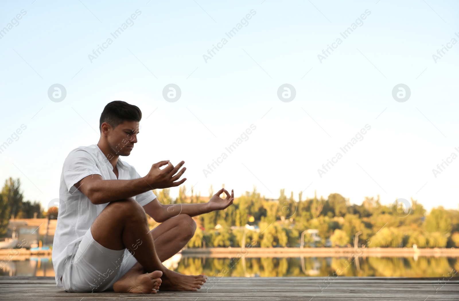 Photo of Man near river at sunset, space for text. Nature healing power