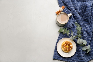 Photo of Flat lay composition with coffee and warm plaid on light table, space for text