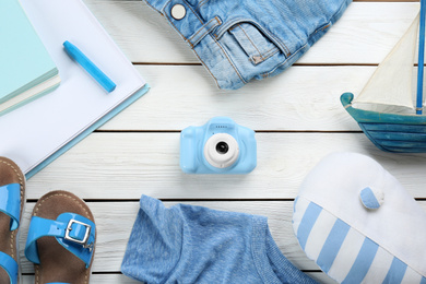 Photo of Flat lay composition with little photographer's toy camera on white wooden background