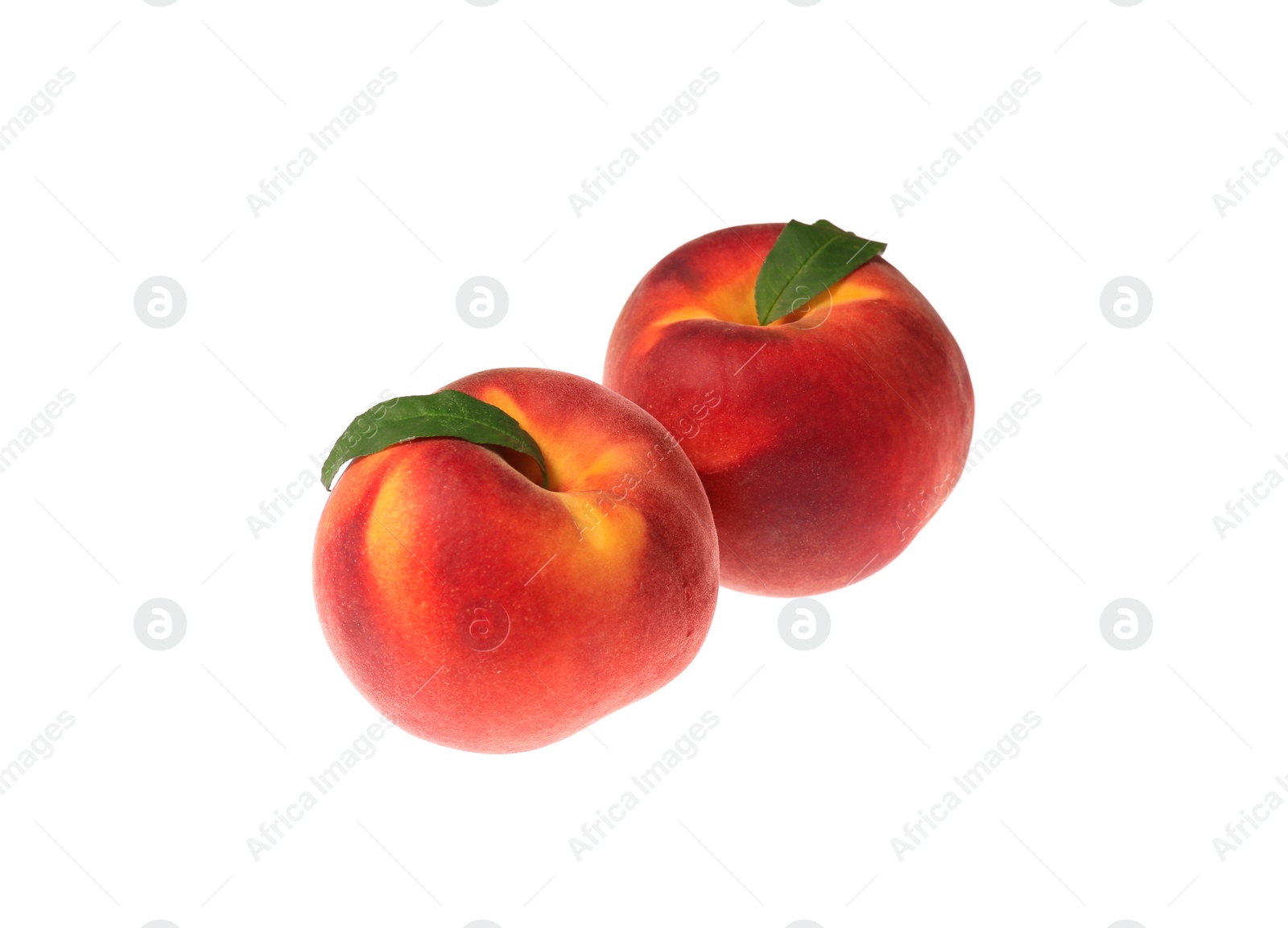 Photo of Delicious fresh ripe peaches with green leaves isolated on white