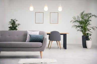 Soft pillows on grey sofa in living room