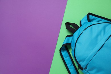 Photo of Stylish light blue backpack on color background, top view. Space for text