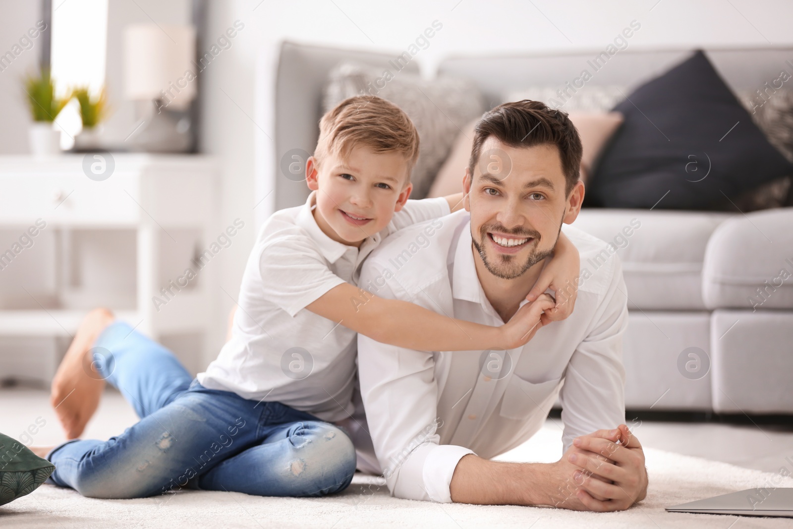 Photo of Little boy and his dad spending time together at home