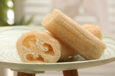 Photo of Loofah sponges on coffee table indoors, closeup