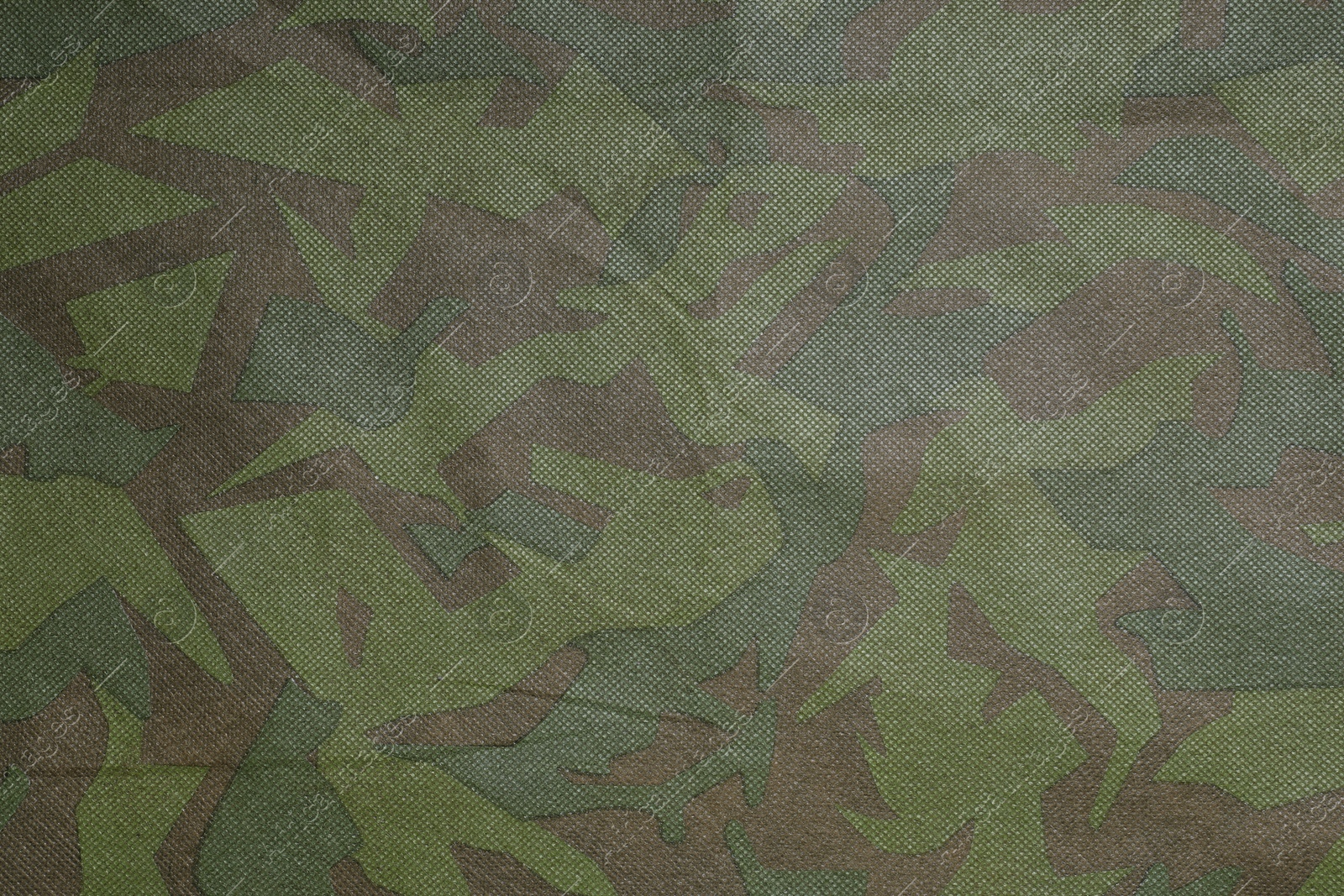 Photo of Texture of camouflage fabric as background, top view