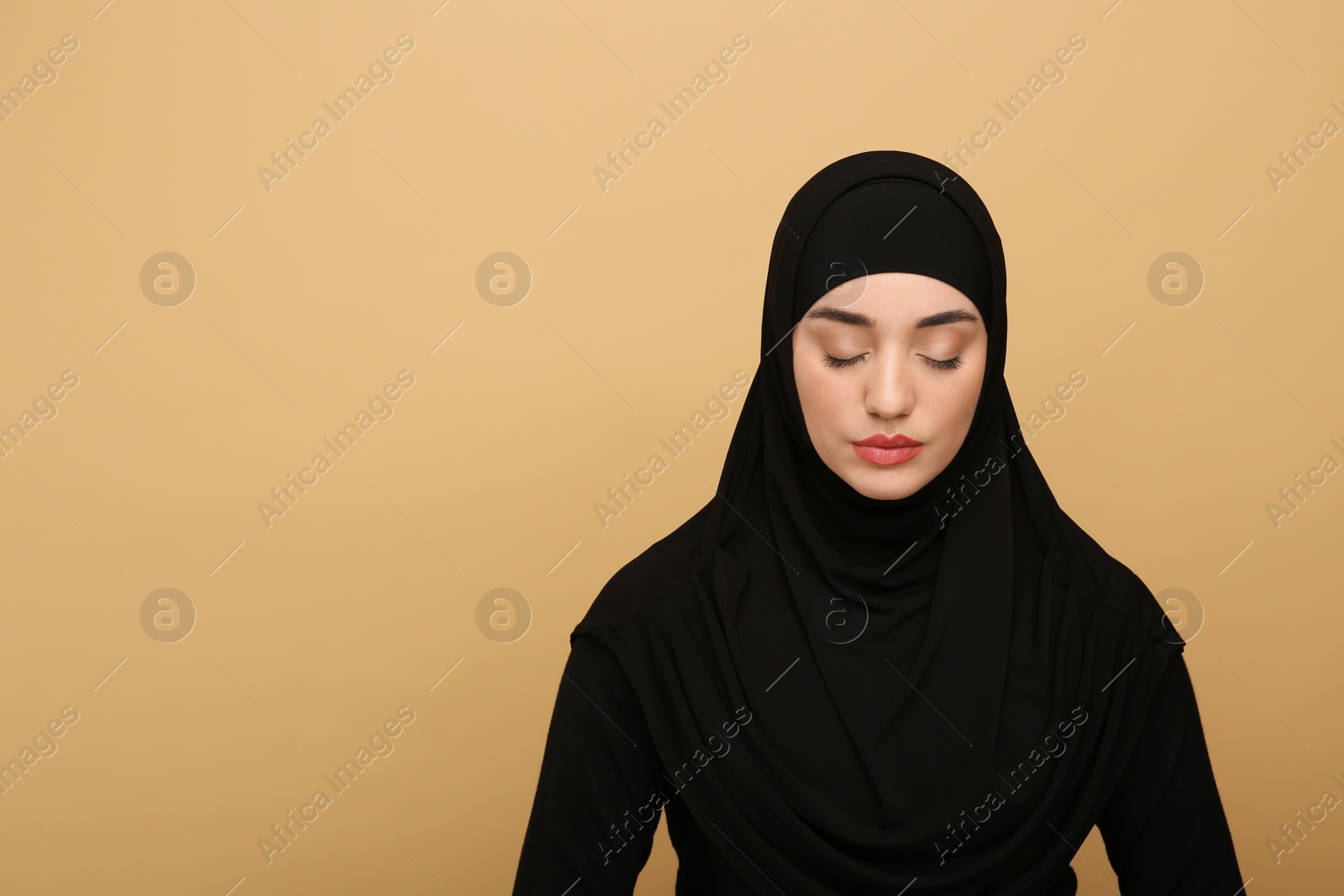 Photo of Portrait of Muslim woman in hijab on beige background, space for text