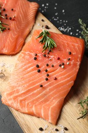 Fresh raw salmon and ingredients for marinade on black table