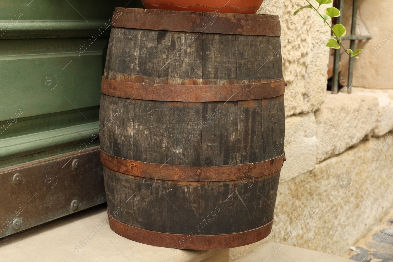 Photo of Traditional wooden barrel on street outdoors. Wine making