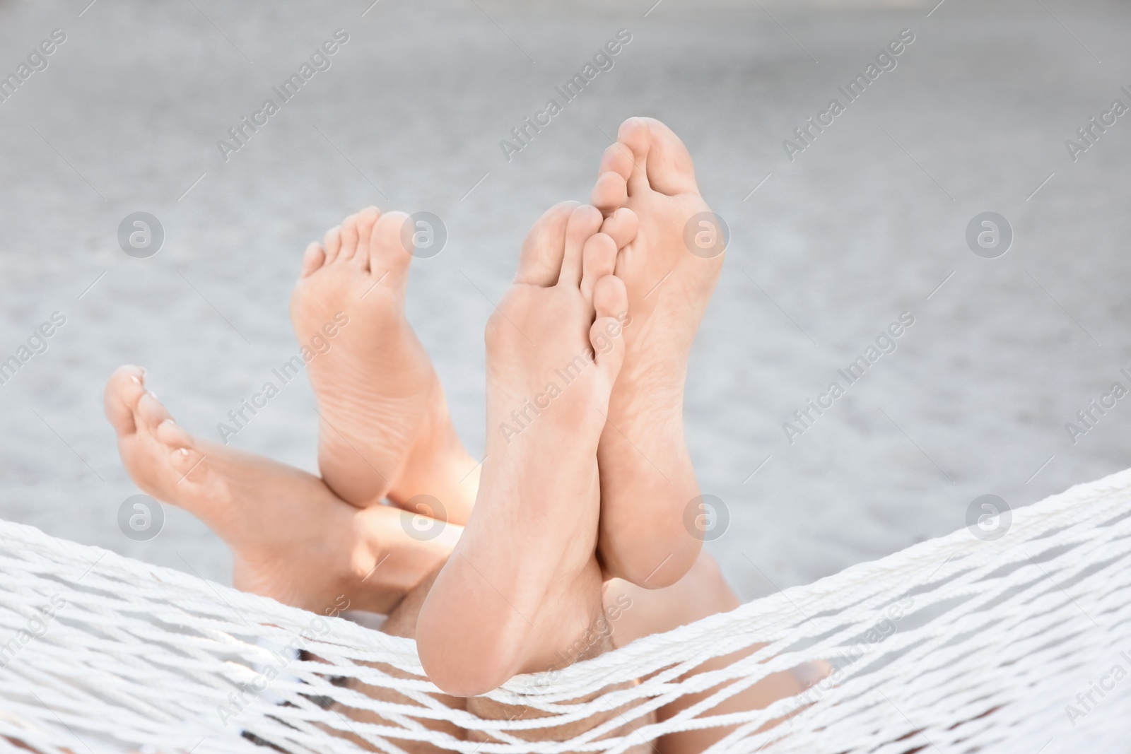 Photo of Young couple resting in hammock at seaside. Summer vacation