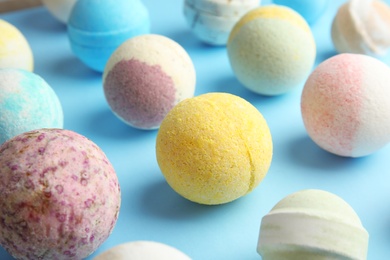 Photo of Many different bath bombs on color background