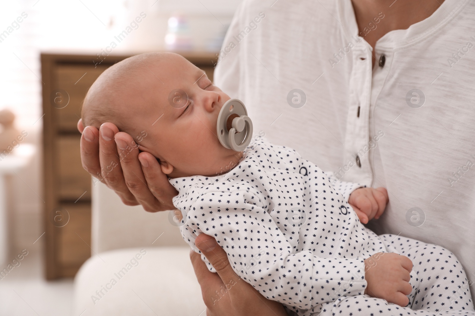 Photo of Father with his cute sleeping baby at home, closeup