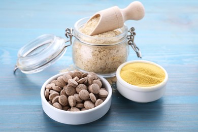 Photo of Different types of brewer's yeast on light blue wooden table