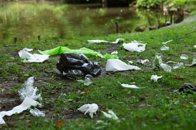 Photo of Garbage scattered on green grass in park