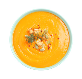 Image of Tasty creamy pumpkin soup in bowl on white background, top view