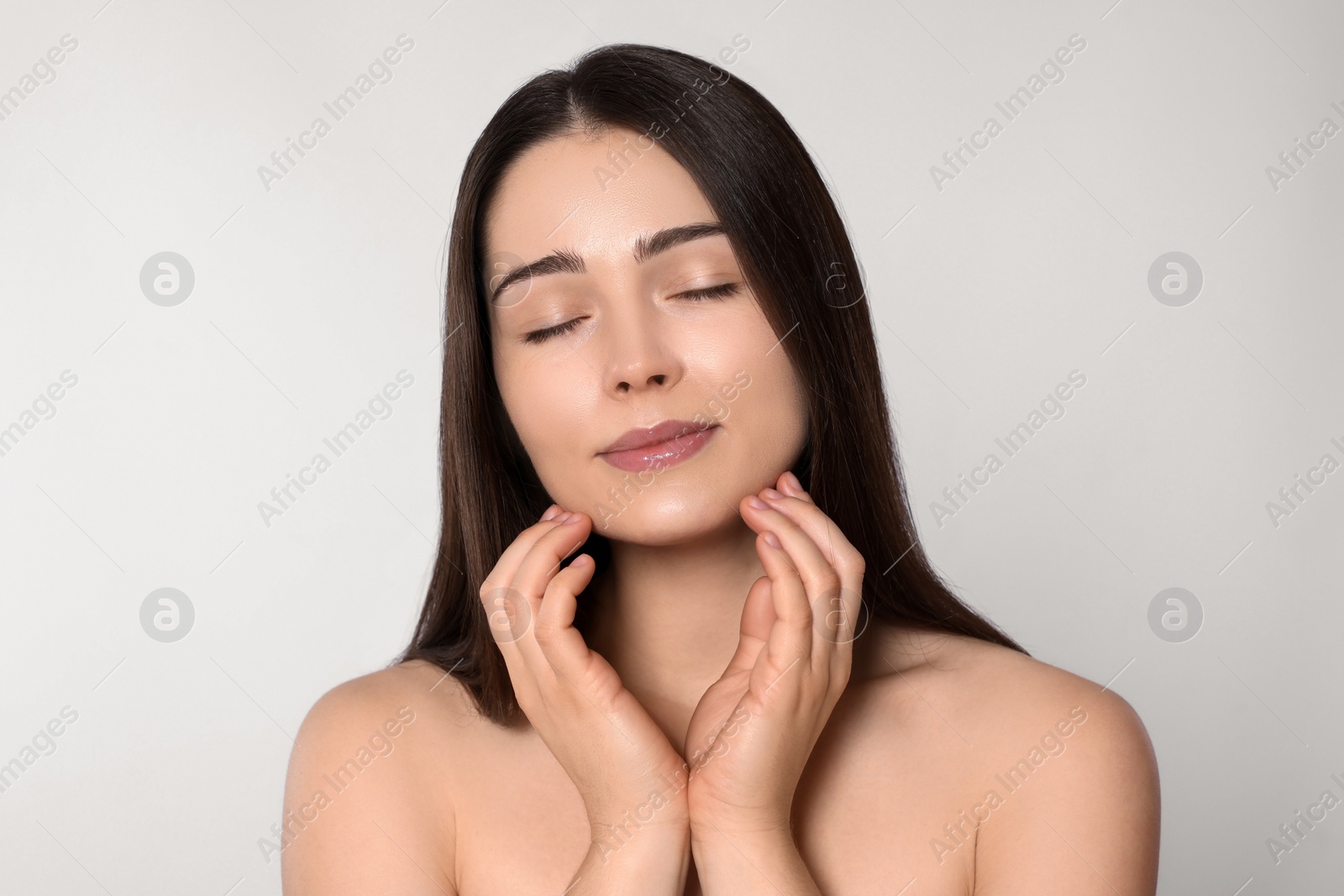 Photo of Portrait of attractive young woman on light grey background. Spa treatment