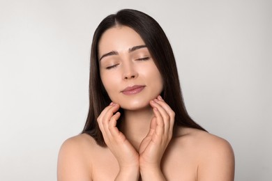 Portrait of attractive young woman on light grey background. Spa treatment