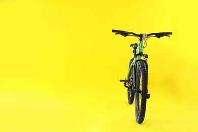 Modern bicycle on yellow background. Space for text