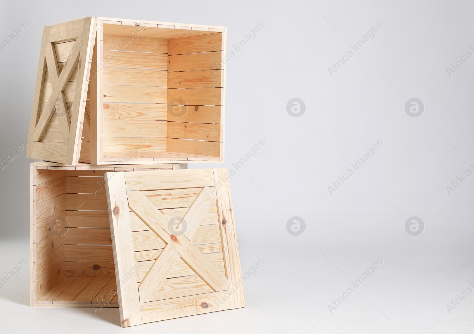 Photo of Wooden crates on grey background. Space for text