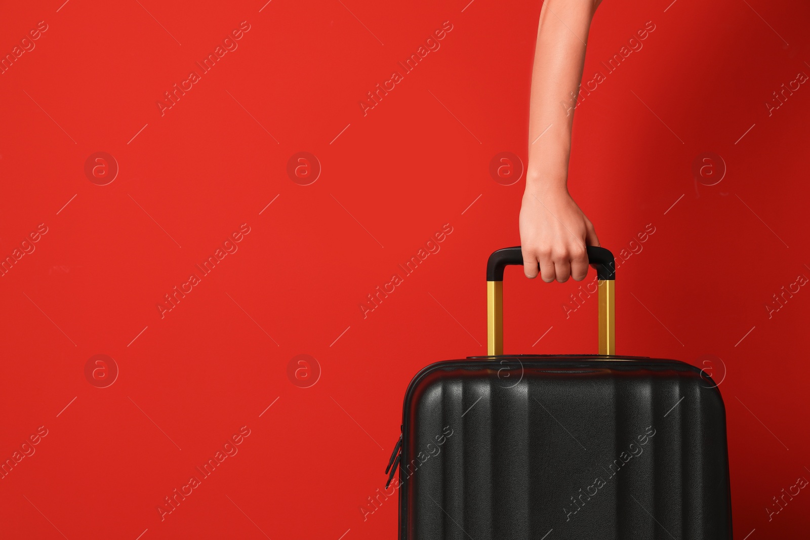 Photo of Woman with stylish suitcase against color background, closeup. Space for text