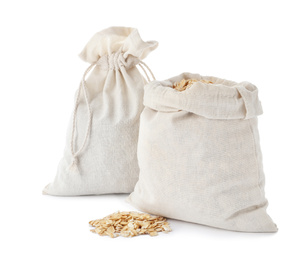 Photo of Cotton eco bags with oat flakes isolated on white